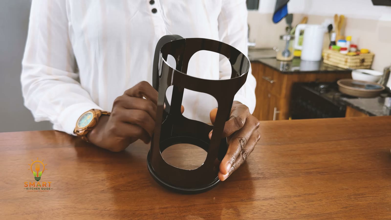 The empty stainless steel frame and handle of the BAYKA French press with the glass carafe removed