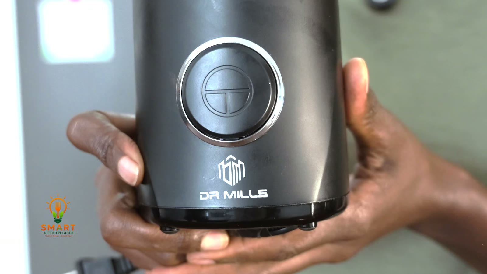 Front of the black Dr. Mills DM-7441 coffee grinder with its single push button