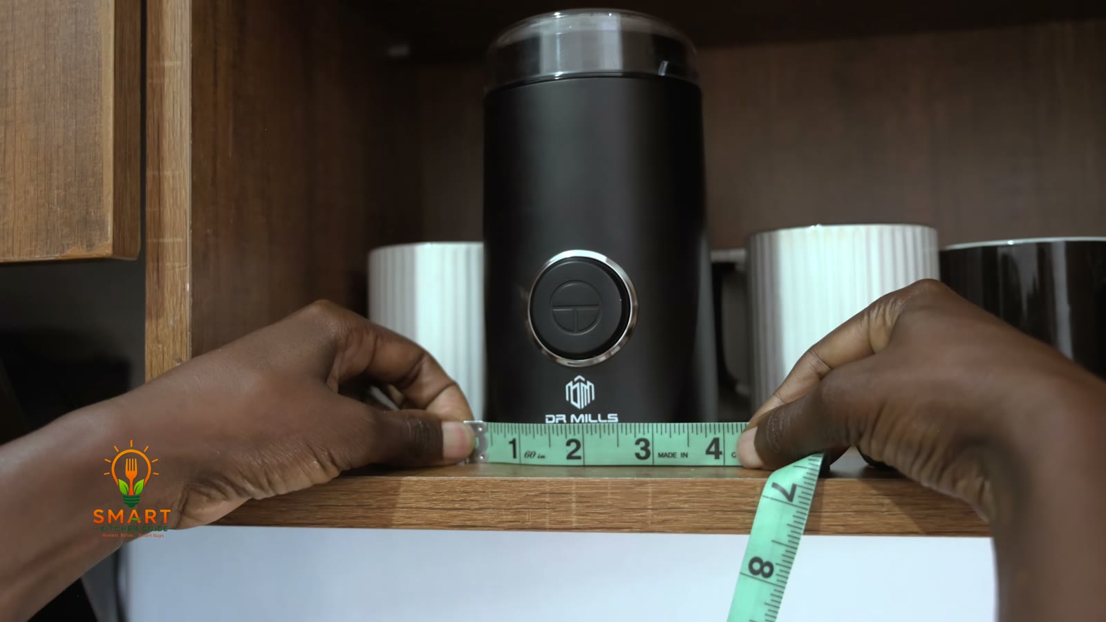 Measuring the Dr. Mills DM-7441 grinder on a shelf with a tape measure — about 4 inches wide