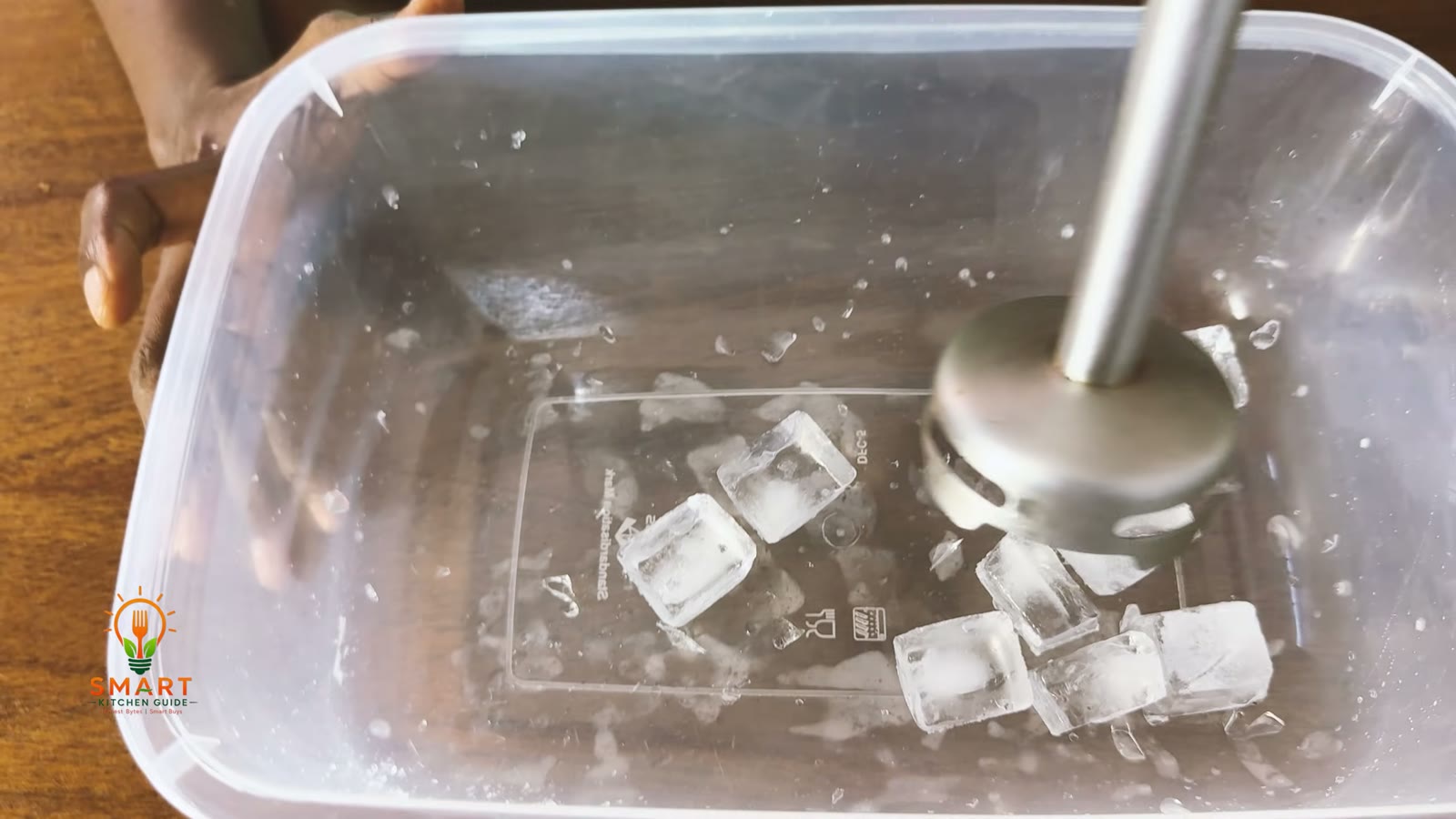 George Home GHB301B-19 hand blender in a tub of ice cubes with only a few chips and shards broken off