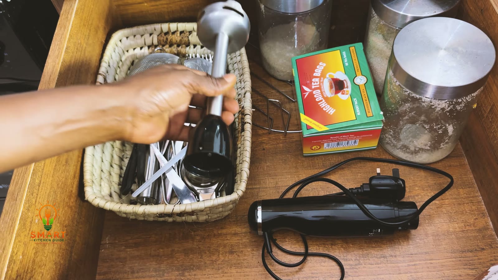 The George Home GHB301B-19 stored as two pieces: stainless steel shaft in a utensil basket and motor body beside it in a kitchen drawer