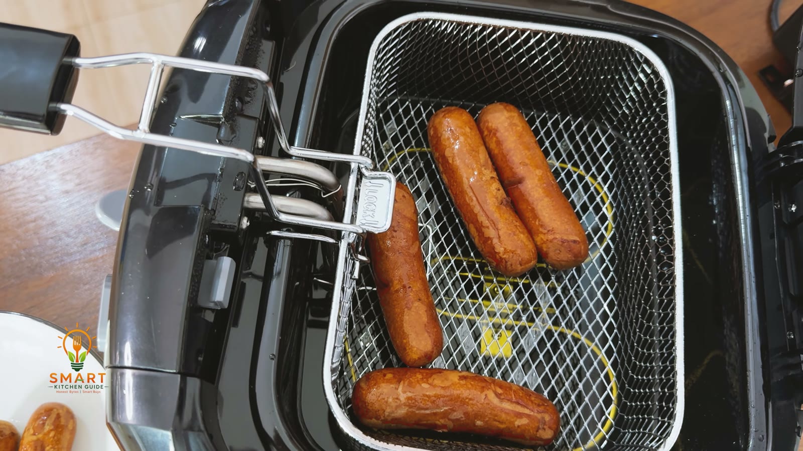Fried sausages drained in the raised basket of the Hamilton Beach 35021 deep fryer