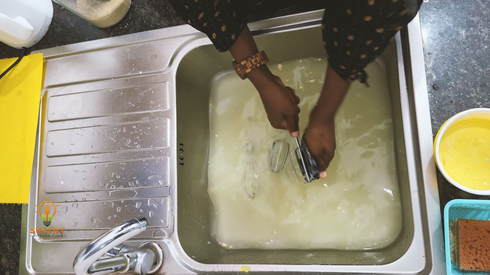 Washing the Hamilton Beach 64655 beaters and whisk in a sink of soapy water