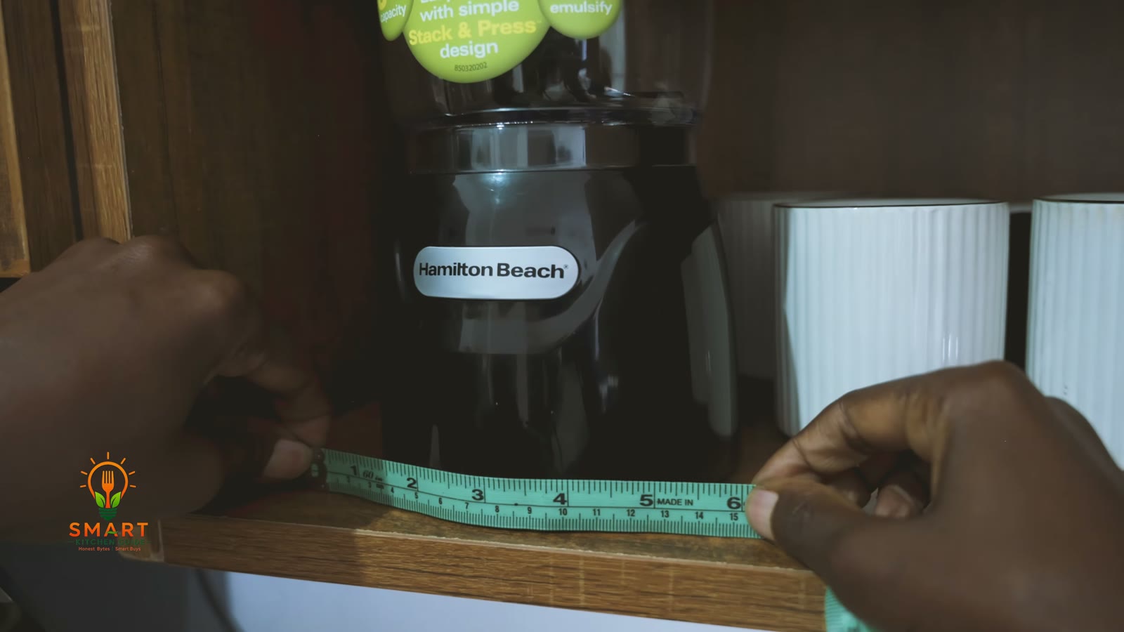 Measuring the Hamilton Beach Stack & Press 72850 chopper on a kitchen shelf with a tape measure