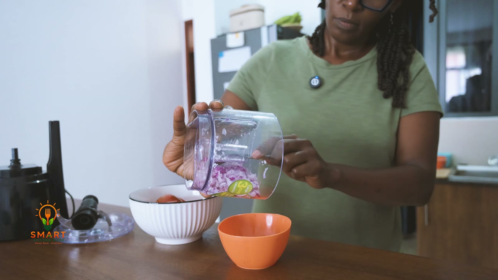 Pouring chopped onion from the Hamilton Beach 72850 bowl into a serving bowl