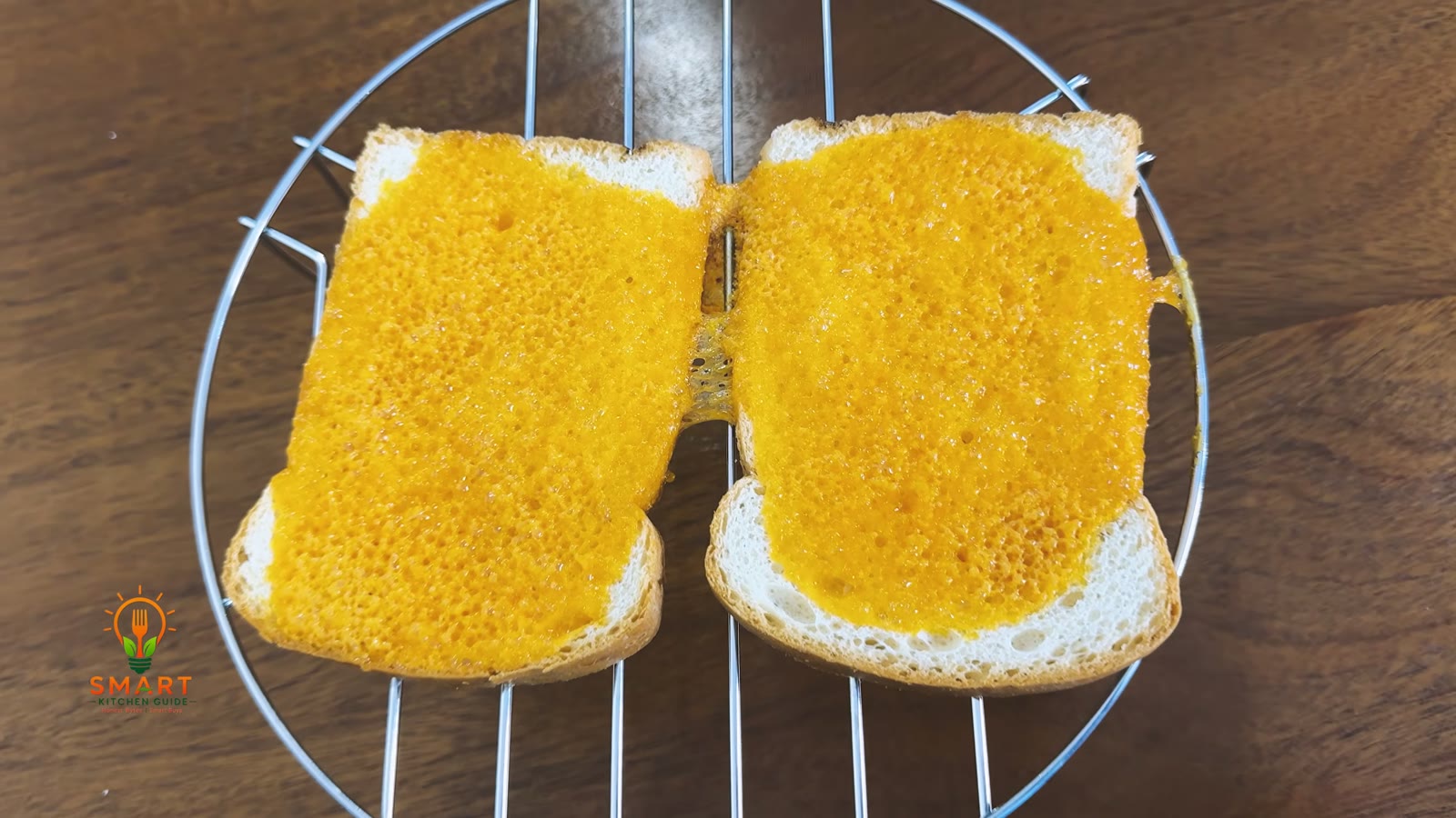 Two slices of cheese toast with bubbly melted cheese on the metal rack after 5 minutes on the Kenwood MWM25.000BK grill