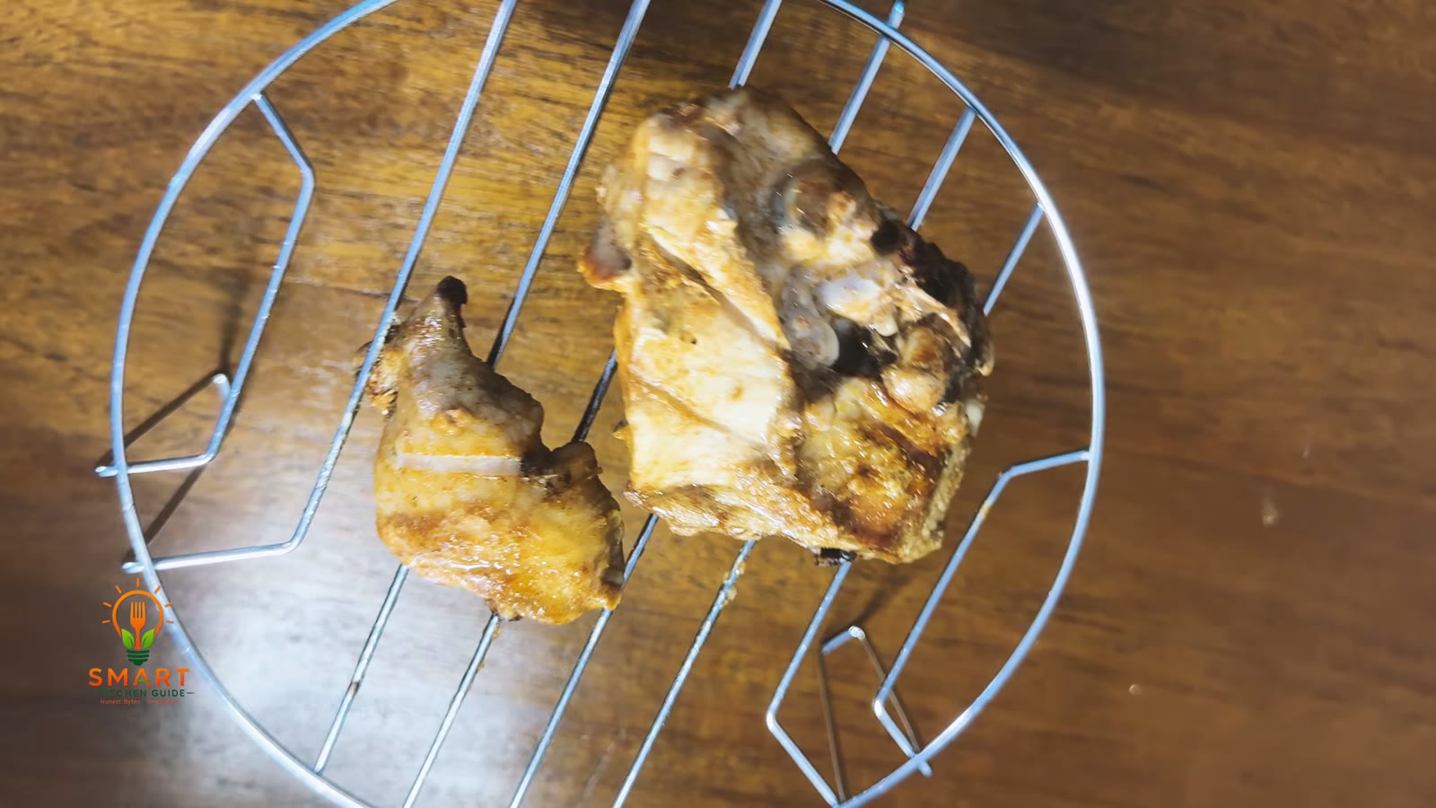 Golden brown chicken pieces on the metal rack after 12 minutes of C-1 combination cooking in the Kenwood MWM25.000BK