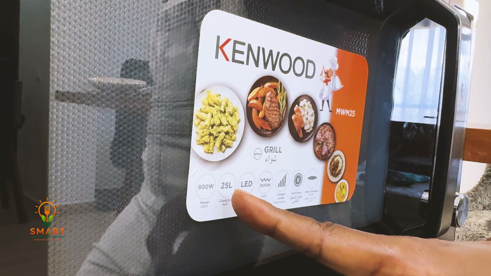 Kenwood sticker on the door of the MWM25 microwave listing 800 W power, 25 L capacity, 1000 W grill, 5 power levels, 8 auto menus and a 27 cm glass turntable