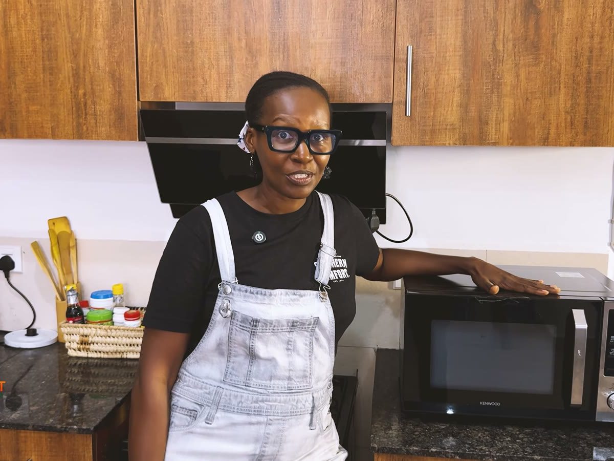 Jackie from The Smart Kitchen Guide beside the Kenwood MWM25.000BK 25 L microwave with grill on her kitchen counter