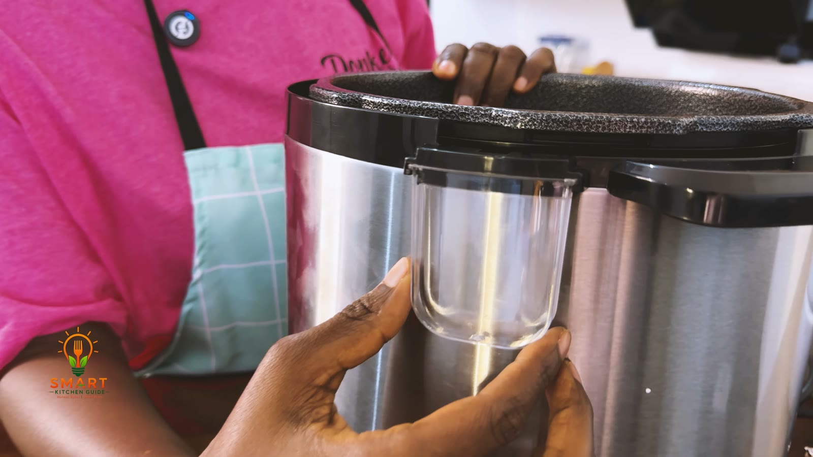 Clear condensation cup sliding into the slot at the back of the Saachi NL-PC-5306 pressure cooker