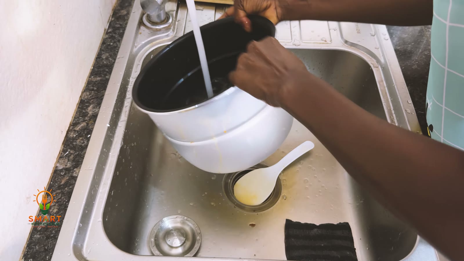 Washing the inner pot and serving spoon of the Saachi NL-PC-5306 under the kitchen tap